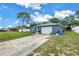 A quaint one-story home with a front lawn and a driveway leading to an attached garage at 2270 Amherst Ave, Spring Hill, FL 34609