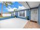 Inviting front patio with a window and secure metal gate for enhanced curb appeal at 2270 Amherst Ave, Spring Hill, FL 34609