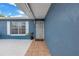 Welcoming covered front porch with tiled walkway and a secure metal gate at 2270 Amherst Ave, Spring Hill, FL 34609