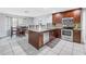 Kitchen featuring a modern island, stainless steel appliances, and an adjacent dining area at 2270 Amherst Ave, Spring Hill, FL 34609