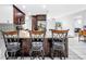 Kitchen island with granite countertops and dark wood cabinetry, open to living area at 2270 Amherst Ave, Spring Hill, FL 34609