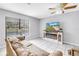 Comfortable living area boasting a faux fireplace, a ceiling fan, and a large window at 2270 Amherst Ave, Spring Hill, FL 34609