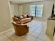 Cozy living room with tile floors, a ceiling fan, and a bright, airy atmosphere at 2270 Amherst Ave, Spring Hill, FL 34609