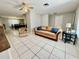Open-concept living room featuring tile flooring, neutral tones, and a ceiling fan at 2270 Amherst Ave, Spring Hill, FL 34609