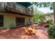 Brick patio offers an outdoor dining space with a picnic table, seating, and a swing at 2279 Ranchette Ln, Dunedin, FL 34698