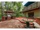 Backyard area with brick patio, gazebo, built-in grill and an overhanging deck at 2279 Ranchette Ln, Dunedin, FL 34698