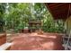 Expansive backyard with brick patio, custom outdoor kitchen, gazebo, and play area at 2279 Ranchette Ln, Dunedin, FL 34698