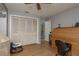Bedroom with wood floors, folding closet doors and a view into a bathroom at 2279 Ranchette Ln, Dunedin, FL 34698