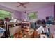 Eclectic bedroom with a variety of tables, boxes and storage at 2279 Ranchette Ln, Dunedin, FL 34698