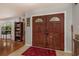 Welcoming foyer featuring gorgeous double doors and plenty of natural light at 2279 Ranchette Ln, Dunedin, FL 34698