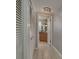 Hallway view leading to bathroom with a closet on the left and view of the vanity and mirror at 2279 Ranchette Ln, Dunedin, FL 34698