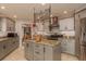 Well-equipped kitchen with stainless steel appliances, granite countertops, and kitchen island storage at 2279 Ranchette Ln, Dunedin, FL 34698