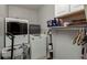 Clean laundry room with white cabinets and appliances at 2279 Ranchette Ln, Dunedin, FL 34698