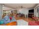 Spacious living room with hardwood floors, comfortable seating, and an adjacent dining area and large-screen tv at 2279 Ranchette Ln, Dunedin, FL 34698