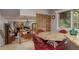 Cozy living room featuring dining area, stone fireplace, access to backyard at 2279 Ranchette Ln, Dunedin, FL 34698