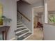 Stairway leading to another level with view to sitting area with tile floors and a view to the exterior at 2279 Ranchette Ln, Dunedin, FL 34698