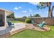 Well-maintained backyard with a fire pit, seating area, patio, and lush green lawn, ideal for outdoor living and entertaining at 2701 65Th Ave S, St Petersburg, FL 33712