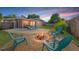 Inviting backyard oasis with a cozy fire pit and comfortable seating for relaxation and entertaining with a colorful sunset at 2701 65Th Ave S, St Petersburg, FL 33712