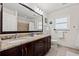Bathroom featuring double sinks with granite countertops and large mirror at 2701 65Th Ave S, St Petersburg, FL 33712