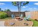 Cozy backyard fire pit area surrounded by Adirondack chairs, gravel and landscaping, perfect for outdoor gatherings and relaxation at 2701 65Th Ave S, St Petersburg, FL 33712