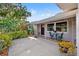 Inviting front porch features a cozy seating area, potted plants, and a charming entryway, adding character to the home at 2701 65Th Ave S, St Petersburg, FL 33712