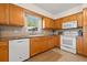 Well-lit kitchen with wood cabinets, tile flooring, and modern appliances at 2701 65Th Ave S, St Petersburg, FL 33712