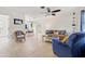 Bright living room boasts tile flooring, a ceiling fan, and a view into the dining area, creating an open and airy space at 2701 65Th Ave S, St Petersburg, FL 33712
