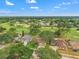 Aerial view of homes bordering the golf course, surrounded by lush trees and greenery at 2713 Brianholly Dr, Valrico, FL 33596