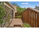 Side yard of home featuring a wooden boardwalk and colorful flower bed at 2713 Brianholly Dr, Valrico, FL 33596