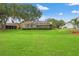 View of spacious backyard with a screened-in lanai, set against a backdrop of green grass at 2713 Brianholly Dr, Valrico, FL 33596