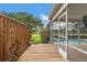 Wooden walkway leading to screened-in pool area overlooking beautifully landscaped yard at 2713 Brianholly Dr, Valrico, FL 33596
