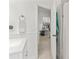 Bright bathroom with a white vanity and wainscoting, offering a doorway view to the kitchen at 2713 Brianholly Dr, Valrico, FL 33596