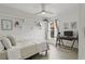 Inviting bedroom featuring a ceiling fan, shelving, and a comfortable workspace at 2713 Brianholly Dr, Valrico, FL 33596