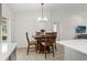 Bright dining area with a modern chandelier and a wooden table for four, creating a cozy eating space at 2713 Brianholly Dr, Valrico, FL 33596