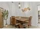 Cozy dining room with light wood floors, modern lighting, and a bench seating arrangement at 2713 Brianholly Dr, Valrico, FL 33596