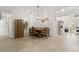 Stylish dining room featuring light wood floors, modern lighting, and an adjacent living area at 2713 Brianholly Dr, Valrico, FL 33596