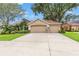 Charming single-Gathering home with a spacious two-car garage, complimented by tropical landscaping at 2713 Brianholly Dr, Valrico, FL 33596