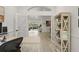 Spacious home office with double doors leading to the main area, showcasing modern shelving and wood-look tile flooring at 2713 Brianholly Dr, Valrico, FL 33596