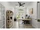 Bright home office with a ceiling fan, natural light, and a stylish built-in bookshelf, perfect for remote work at 2713 Brianholly Dr, Valrico, FL 33596