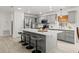 Bright, modern kitchen features gray cabinets, stainless steel appliances, and a spacious island with seating at 2713 Brianholly Dr, Valrico, FL 33596