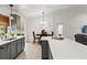 Open kitchen with island, bar stools, stainless steel appliances, and an adjacent dining area at 2713 Brianholly Dr, Valrico, FL 33596