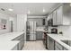 Well-lit kitchen featuring stainless steel appliances, a large refrigerator, and ample counter space at 2713 Brianholly Dr, Valrico, FL 33596