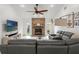 Inviting living room with a brick fireplace, vaulted ceilings, and a comfortable sectional sofa, perfect for relaxation at 2713 Brianholly Dr, Valrico, FL 33596