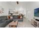 Open-concept living room with a modern sectional sofa, seamlessly connecting to the kitchen and dining area at 2713 Brianholly Dr, Valrico, FL 33596