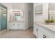 Spacious bathroom with dual sinks, ample vanity space, wood-look tile flooring and a shower with glass door at 2713 Brianholly Dr, Valrico, FL 33596