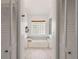 Bright bathroom featuring a large soaking tub with glass block window, dual closets, and wood-look tile flooring at 2713 Brianholly Dr, Valrico, FL 33596