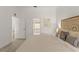 Comfortable main bedroom with stylish headboard, neutral tones, and an ensuite bathroom for ultimate privacy at 2713 Brianholly Dr, Valrico, FL 33596