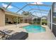 Outdoor pool area surrounded by the screened-in patio with lounge chairs at 2713 Brianholly Dr, Valrico, FL 33596