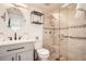 Modern bathroom featuring a glass-enclosed shower, vanity, and decorative fixtures at 28 Seaside Ct, Holmes Beach, FL 34217
