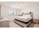 Bright bedroom with wood-look floors, wood-frame bed, and neutral decor at 28 Seaside Ct, Holmes Beach, FL 34217